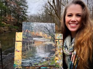 Jessica Henry Gray pictured with a plein air painting